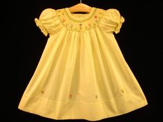 "Favorite / \"heart\" this beautiful dress (add to collection) and get 10% discount coupon  Let's make your Baby Girl look like a Baby Princess ! New hand-made : Boutique Hand-embroidered Bishop Smocked Dress - sweet Yellow . Features: All hand-crafted with sophisticated hand-smocking around neck from front to back, plus on the puff sleeves. Adorable hand-embroidery with butterflies & flowers in very beautiful color arranging and interesting details.... Short puffed sleeves. Large hem with approximately 3\" length. 2-3 flower-shaped sweet pink buttons on the upper back of dress. Dress material : 100% deluxe cotton for children comfort. Dress color: beautiful sweet Yellow . Suggest Retail Price : $190 This style is available in : Size 6M ; Size 12M ; Size 18M ; Size 24M ; Size 2 ; Size 3 ; Yellow Smocked Fitted Dress, Fitted Smock Yellow Dress, Fitted Yellow Smock Dress, Yellow Fitted Smock Dress, Fitted Yellow Smocked Bodice Dress, Fitted Yellow Smocked Dress With Smocked Bodice, Fitted Yellow Smocked Dress, Yellow Smock Cotton Dress, Yellow Cotton Smock Dress