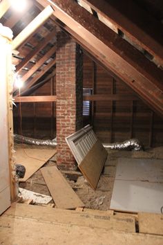 an attic with exposed walls and wood flooring in the process of remodeling