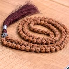 📿This Ancient Mala is crafted with Rudraksha Beads. They are strung on a durable nylon silk cord which creates a feeling of euphoria in meditation or drapes gracefully when worn as a necklace. Suspended in the centre is an Oxidized Silver Plated Copper Guru Bead. A hand-tied silk tassel also in matching brown colour completes this stunning piece. Historically, the tassel has worked as a talisman and is used as a sign of power, prestige, protection, and spiritual significance. This Mala is used Festive Spiritual Beaded Necklaces, Gemstone Beaded Necklaces For Puja And Festivals, Round Beads For Rituals And Festivals, Adjustable Hand-strung Beaded Necklaces For Puja, Adjustable Beaded Mala For Puja, Multicolor Round Beads Mala For Puja, Handmade Mala For Meditation And Diwali, Handmade Mala For Diwali Meditation, Festive Spiritual Beaded Mala