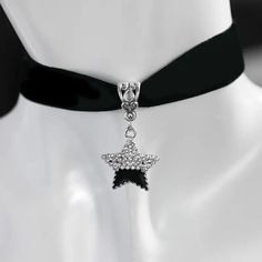 Make a statement with this beautiful handmade choker necklace featuring a half black, half rhinestone star pendant. Perfect for those who love all things Gothic and space-themed. Adjustable velvet strap with a lobster closure for easy wear. Ideal for special occasions like weddings, graduations, and anniversaries. #chokernecklace #gothicstyle #spacethemed #starnecklace #handmadejewelry #statementpiece 🌟🖤✨ #chokerjewelry #chokernecklace #jewelryshop #jewelrylovers #jewelrystore #cutechokers Silver Star-shaped Choker For Party, Black Rhinestone Choker Jewelry, Black Rhinestone Choker Necklace Gift, Black Costume Jewelry With Rhinestones, Adjustable Black Rhinestone Necklace For Party, Black Rhinestone Costume Jewelry, Trendy Black Crystal Jewelry, Trendy Black Bling Jewelry, Black Metal Necklace With Rhinestones