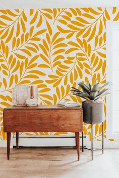 an orange and white wallpaper with yellow leaves on it in a living room area