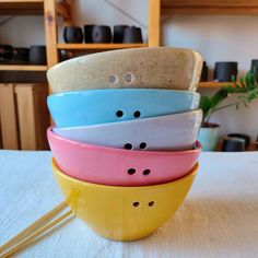 a stack of four bowls sitting on top of a table