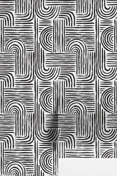 an abstract black and white wallpaper with wavy lines in the shape of letters on it