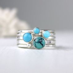 Turquoise and silver stacking rings created from recycled silver and four different turquoise gemstones. For the largest stone you can choose to either have one with lovely matrix (first picture) or solid color (fifth picture). The others are different complimentary shades of solid blue. The rings coordinate beautifully giving you many options. Artfully simple if worn alone, they can be worn with other stacking rings for a pop of color. Also, available with oxidized finish (last picture). If you Stackable Turquoise Round Jewelry, Unique Stackable Turquoise Jewelry, Unique Turquoise Stackable Jewelry, Unique Stackable Turquoise Ring, Handmade Turquoise Stackable Rings In Sterling Silver, Blue Turquoise Stackable Round Ring, Stackable Round Turquoise Ring In Blue, Turquoise Gemstone Stackable Rings, Stackable Sterling Silver Turquoise Ring