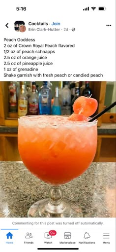 an orange cocktail in a glass on top of a counter