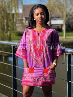 This beautiful dashiki dress / shirt can be worn by both men and women. It may be paired with jeans, leggings or a waist belt to make it more defined. For some, it can also be worn as a mini dress. This dress / shirt is perfect for any occasion. This shirt should traditionally be worn oversized. * Short Sleeve Shirt * Made of 100% Cotton * 2 Front pockets * Handwash recommended if possible or machine wash inside out at maximum 40 degrees celcius. This dashiki is made of original Angelina Java fa Casual Purple Kaftan For Spring, Printed Short Sleeve Tunic For Festivals, Short Sleeve Printed Tunic For Festival, Casual Short Sleeve Tunic For Festival, Pink Tunic Kaftan Casual Style, Fitted Casual Tunic For Vacation, Casual Long Sleeve Kaftan For Festival, Casual Printed Tunic Kaftan, Casual Festival Kaftan With Vibrant Print