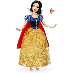 the snow queen doll is wearing a gold dress and red cape with her hands out