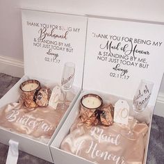 two personalized wedding gift boxes with champagne glasses and napkins in them, one for bride and the other for groom