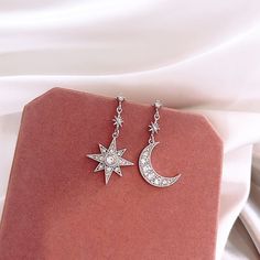 You can be the star of the show with these sparkly celestial stars and moon earrings! The asymmetry is very on-trend right now and will have all your friends asking about them!. Wear these on your next special occasion! DETAILS & SIZE Finish: Gold or silver plate Material: Alloy; CZ crystals Measurements: Moon and star pendants: 18mm length Comes with friction earring backs Shop the Celestial collection for more options! Or shop Earrings for more options! Celestial Crystal, Silver Star Earrings, Celestial Earrings, Moon And Star Earrings, Star And Moon, Crystal Fashion, Mismatched Earrings, Star Moon, Crystal Stars