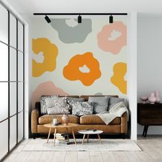 a living room with an orange and gray flower wallpaper