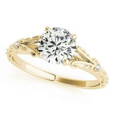 a yellow gold engagement ring with a round diamond in the center and scrolls around it