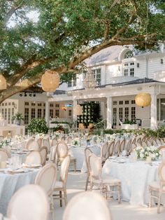 an outdoor wedding venue with tables and chairs