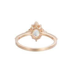 a gold ring with an oval stone in the center and small diamonds on each side