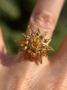 This a beautiful piece of art by a jeweler at some point. The artist has created a beautiful sunburst and it rests atop a comfort band. It's actually quite comfortable to wear.  The sun is a .9" round face and sits .3" (or 8.5mm) off the finger.  It is currently sized 4.5 and resizable. The band is a 3mm band.  No markings but tests 18k.  Weighs 6.77g Elegant Sunburst Jewelry With Sun And Moon Design, Elegant Sun And Moon Design Sunburst Jewelry, Elegant Starburst Sun Design Jewelry, Elegant Sun Design Starburst Jewelry, Formal Yellow Gold Starburst Jewelry, Formal Gold Starburst Jewelry, Sun Engagement Ring, Sun Ring, Gold Sun