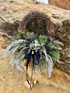 a wreath is hanging on the side of a rock