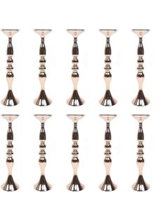 six silver candlesticks are lined up against a white background