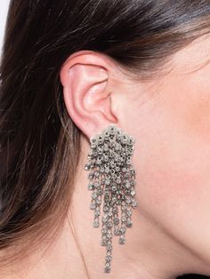 The Madonna Statement Earrings feature layers of crystal embellishments on a comfortable clip back, creating a classic statement look that pairs perfect with the matching bracelet and necklace. From Sorrelli's Crystal collection in our Palladium Silver-tone finish. Silver Clip-on Crystal Earrings For Party, Sparkling Silver Clip-on Earrings For Evening, Glamorous Silver Clip-on Earrings With Rhinestones, Evening Metal Clip-on Crystal Earrings, Metal Clip-on Crystal Earrings For Evening, Glamorous Metal Clip-on Earrings For Evening, Silver Jeweled Clip-on Earrings, Glamorous Evening Metal Clip-on Earrings, Elegant Evening Metal Crystal Clip-on Earrings