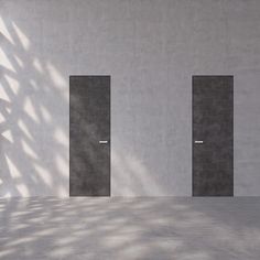 an empty room with two open doors in the wall and shadows on the floor behind it