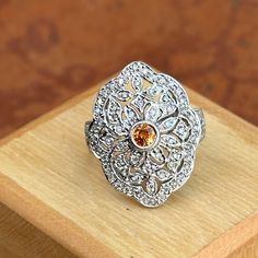 Vintage, Art Deco 14KT white gold round, center citrine and diamond filigree design ring. Size 6.25 Can be resized for an additional fee Weight: 5.80 grams Stone measures: 3.5mm Stamped 14K & hallmarked .50 ct natural diamonds; I1-2/ H-J Very Good Condition Low profile setting Elegant Citrine Diamond Ring With Accents, Elegant Orange Diamond Ring For Gift, Elegant Orange Topaz Ring With Center Stone, Vintage Luxury Filigree Ring With Center Stone, White Gold Filigree Ring With Accent Stones, Elegant Orange Topaz Round Ring, Topaz Filigree Round Ring, Elegant Orange Diamond Ring With Gemstone, Elegant Orange Topaz Ring With Diamond