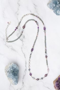 Experience the beauty and versatility of the Reflections Collection. Each piece is thoughtfully handcrafted using carefully chosen materials. This collage necklace measures 29.5-31.5" and is completed an antique silver plated brass extender chain and lobster claw clasp. Elevate your style with Reflections. Antique Silver Plated Brass (lead and nickel free) Amethyst, Blue Lace Agate, Pearl 29.5-31.5", adjustable with antique silver plated brass lobster claw clasp We hand select our natural materi Bohemian Silver Agate Beaded Necklace, Bohemian Silver Amethyst Beaded Necklace, Silver Beaded Agate Necklace, Silver Agate Crystal Necklace With Gemstone Beads, Silver Beaded Agate Necklaces With Natural Stones, Silver Beaded Necklace With Agate, Spiritual Silver Single Strand Crystal Necklace, Artisan Silver Agate Beaded Necklace, Silver Agate Beaded Necklaces For Jewelry Making