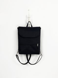 ► Black Aesthetic Backpack for minimal style lover Women. This waterproof Crossbody bag Backpack made with many pockets.  Midi-sized convertible backpack is great for everyday use, trips, and work. ► SIZE This bag is available in one size. But please contact me if you would like to change the dimensions! :) H 12,5 inch (32cm) * W bottom 9,5 inch (24cm) * D 4 inch (10cm) ► COLOR I can make this bag in many colors. If you like this design, any color variation is possible. You can see the available Minimalist Backpack For Everyday Use, Everyday Anti-theft Backpack Shoulder Bag, Versatile Everyday Backpack With Anti-theft Pocket, Minimalist Everyday Standard Backpack, Multifunctional Everyday Backpack With Zipper Pocket, Minimalist Rectangular Travel Backpack, Minimalist Backpack With Adjustable Strap, Minimalist Shoulder Bag Backpack For Travel, Minimalist Backpack Shoulder Bag With Adjustable Strap