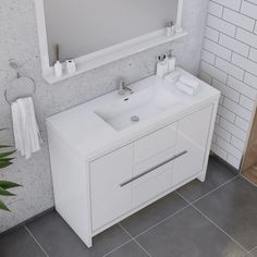 a bathroom vanity with a mirror above it and a plant in the corner next to it