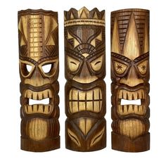 three carved wooden tiki masks on white background