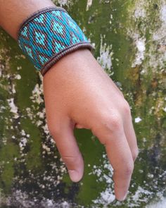 a person's hand with a bracelet on it