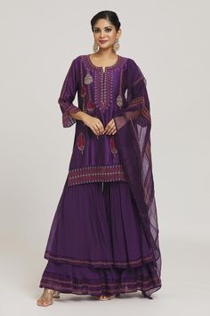 Violet kurta with bead and zardozi embellished floral motifs. Comes with embroidered layered sharara and dupatta.
Components: 3
Pattern: Embroidered
Type Of Work: Zardozi, Bead, Gota
Neckline: Round
Sleeve Type: Three quarter
Fabric: Pure Silk, Satin Doppy
Color: Purple
Other Details: 
Sheer back panel
Closure: Sharara: Drawstring
Occasion: Sangeet,Wedding - Aza Fashions Festive Purple Palazzo Set With Intricate Embroidery, Festive Purple Embroidered Palazzo Set, Bollywood Style Purple Palazzo Set With Intricate Embroidery, Bollywood Style Purple Embroidered Palazzo Set, Anarkali-style Purple Palazzo Set With Intricate Embroidery, Purple Palazzo Set With Resham Embroidery For Wedding, Traditional Purple Palazzo Set With Intricate Embroidery, Traditional Drape Purple Palazzo Set For Wedding, Purple Traditional Drape Palazzo Set For Wedding