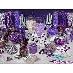 a table topped with lots of purple and white candy