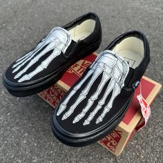 This pair of custom all black Vans feature our Skeleton Bones design. Various sizes available. Canvas uppers. Vulcanized waffle rubber outsoles. Paint is 100% permanent and will never come off. Made in the USA.   Want Black Vans Slip ons with a white rubber midsole? Check these out: https://www.etsy.com/listing/177630379/hand-painted-skeleton-boney-feet-slip-on?ref=shop_home_feat_1&frs=1 We buy each pair of shoes BRAND NEW from the Vans retail store. Each pair is made to order, please make sure you put in the correct shoe size before you check out. The ink is permanent and will never come off. Made in the USA. This price includes everything: shoes, artwork, and shipping. Thanks for stopping by our Etsy shop! Please message us with any questions! Because the artwork is custom made for you, Custom Slip-on Sneakers With Studded Outsoles For Streetwear, Custom Slip-on Sneakers With Vibram Sole For Streetwear, Black Custom Slip-on Sneakers For Streetwear, Black Slip-on Custom Sneakers For Streetwear, Skeleton Vans, Custom Slip On Vans, Painted Skeleton, All Black Vans, Bones Design