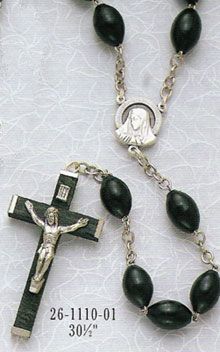 This black Family Wood Rosary from Discount Catholic Products is an elegant piece of religious jewelry. Beautifully made, Discount Catholic Products uses a crucifix with a silver Christ against a black background to make this holy rosary exude a sophisticated feel. Featuring black, wooden oval beads, these rosaries are 30 inches long.These rosaries are perfect for Catholic families or for anyone who makes a habit of praying the rosary. For an elegant and tasteful Catholic ro... Black Wooden Beads Rosary Spiritual Style, Black Wooden Beads Rosary, Black Wooden Beads Spiritual Rosary, Wood Family, Catholic Family, Praying The Rosary, Black Family, Holy Rosary, The Rosary