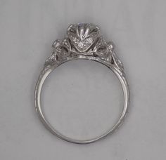 an antique style diamond ring on a white background