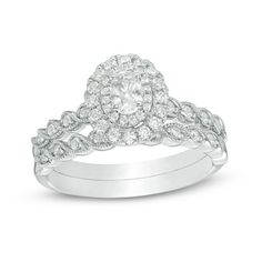 Seal your commitment with this sparkling vintage-inspired diamond bridal set. Crafted in 14K white gold, the engagement ring features a 1/4 ct. oval-cut diamond wrapped in a double frame of diamonds. A milgrain-detailed twist reveals shimmering diamonds along the shank. On your wedding day, the coordinating diamond and milgrain twist shank lends heirloom appeal. Radiant with 3/4 ct. t.w. of diamonds and a brilliant buffed luster, this bridal set is a symbol of your beautiful love story.