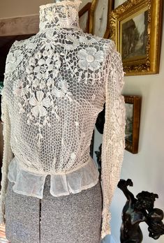 "This is an incredibly lovely hand crocheted blouse purchased from a sale by the Monterey Museum. It dates to the Belle Epoque or Edwardian era and is as wearable today as it was then. The ivory colored crochet has an inner layer of fine netting and it has little hook and eye closures at the back. Size is small or extra small with bust 36\", waist23\", armholes16\", and it is 16\" across the shoulders with 22\" long sleeves and measuring 17\" long from shoulder to beginning of peplum. The blouse Elegant Fitted Lace Top With Crochet Trim, Elegant Long Sleeve Crochet Top With Lace Patchwork, Elegant Lace Blouse With Crochet Trim, Elegant Fitted Top With Crochet Trim, Elegant Long Sleeve Blouse With Crochet Trim, Fitted Crochet Blouse, Vintage White Lace Crochet Top, Vintage White Crochet Lace Blouse, Vintage White Blouse With Crochet Lace