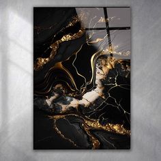 a black and gold abstract painting on a wall