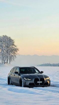 a grey car is driving through the snow