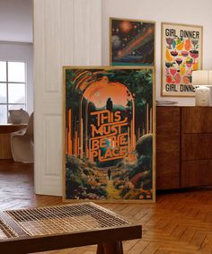 this must be the place movie poster displayed on wall next to wooden table in living room