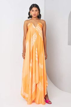 Orange dress with abstract printed patterns in a asymmetric draped silhouette. - Aza Fashions Summer Silk Draped Maxi Dress, Pre-draped Asymmetrical Summer Dress, Pre-draped Midi Dress With Asymmetrical Hem For Summer, Spring Draped Maxi Dress In Viscose, Asymmetrical Silk Maxi Dress For Summer, Summer Asymmetrical Silk Maxi Dress, Summer Maxi Length Pre-draped Dress, Asymmetrical Printed Summer Dresses, Modern Asymmetrical Dress With Asymmetrical Neckline For Summer