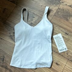 Brand New Align Top With Tags. Never Worn- Too Small And Couldnt Make It Back For A Return At Lulu. Excellent Condition And Still Has All Paddings In Breast. Athleisure Tops With Built-in Bra For Relaxation, Sporty Tops With Built-in Bra For Relaxation, Seamless Athleisure Tops For Relaxation, White Activewear With Built-in Bra, White Athleisure Tops For Relaxation, White Top With Seamless Construction For Light Exercise, White Tops For Light Exercise With Seamless Construction, White Seamless Tops For Light Exercise, Everyday Sleeveless Top With Light Support