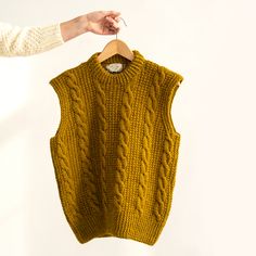 Orla is the classic cabled vest you've been waiting for! Knit in pieces from the bottom up, the beautiful armhole shaping is worked simultaneously with the front and back. A three needle bind off joins the shoulders and cozy folded twisted rib collar finishes it all off. Donegal-based knitter Kathleen Meehan designed Orla in our Erin, an authentic Donegal heather comprised of 60% fine Irish wool and 40% New Zealand wool, it will last you for years to come. Cable Vest, Cable Knit Vest, Bind Off, Vest Pattern, You've Been, Cable Knit, Cable, Wool, Wardrobe