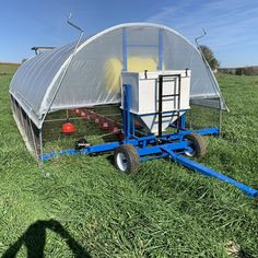 a tractor trailer attached to a small greenhouse