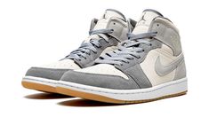 The Air Jordan 1 Mid SE “Coconut Milk” is a versatile look for the mid-top version of Michael Jordan’s first signature shoe that combines a cream-colored base with grey suede overlays.  From Jordan Brand’s Spring 2022 collection, the “Coconut Milk” colorway features a coconut-colored canvas base with contrasting Particle Grey suede overlay panels and Swoosh branding.  A classic “Wings” logo appears on the collar.  A Particle Grey Jumpman with “Air” branding is embroidered on the top of the Cocon Jordan 1 Coconut Milk, Air Jordan 1 Mid Gs, Jordan Model, Air Jordan 1 Mid Se, Nike Air Jordan 1 Mid, Jordan 5, Jordan 3, Air Jordan 1 Mid, Jordan 1 Mid