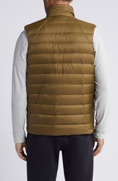 Whether you're deep in the backcountry or just your own backyard, you'll appreciate the cozy core warmth of this vest filled with 750-fill-power down. 26 1/2" length (size Medium) Front zip closure Stand collar Front zip pockets; interior chest zip pocket Durable water-repellent (DWR) finish Packs into pocket Lined, with 750-fill-power down 100% recycled polyamide Machine wash, tumble dry Imported Certified to the Responsible Down Standard (RDS) by Control Union Outdoor Puffer Vest Jacket Sleeveless, Sleeveless Down Puffer Vest, Outdoor Puffer Vest With Down Filling, Outdoor Down Puffer Vest, Outdoor Puffer Vest Made Of Down, Nylon Puffer Vest For Outdoor, Outdoor Nylon Puffer Vest, Cozy Core, Reigning Champ