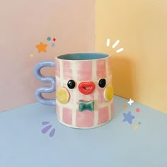 a coffee mug with a face painted on it