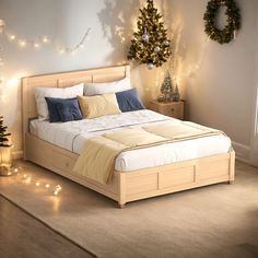 there is a bed that has been made with lights on the wall and christmas decorations around it