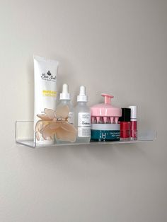 an assortment of beauty products are displayed on a shelf