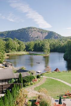 a lake surrounded by lush green trees and mountains