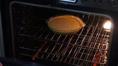 a pie baking in an oven with the light on