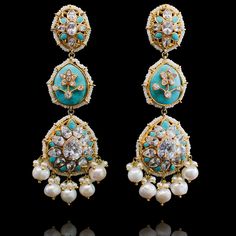 Pull of an ethnic look with a dash of modernity in these stunning earrings! Beautiful, stand-out statement earrings in a mesmerizing design decked out in CZ stones and accented with feroza or pink stones and white pearls. Approximate earrings length is 4". Gold-plated on high-quality brass as base metal. Made by order. Kindly allow 4-6 weeks for the delivery of this item. For custom or urgent requests, please contact support@alacouture.com. *Please Note: We use faux stones and beads in all of ou Luxury Multicolor Temple Jewelry Bridal Earrings, Luxury Multicolor Temple Bridal Earrings, Luxury Multicolor Temple Jewelry Earrings, Elegant Turquoise Kundan Earrings, Turquoise Kundan Earrings For Wedding, Elegant Turquoise Earrings For Festivals, Elegant Turquoise Earrings For Festive Occasions, Elegant Turquoise Earrings For Festive Season, Elegant Turquoise Meenakari Earrings